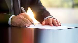 A person writing on a document